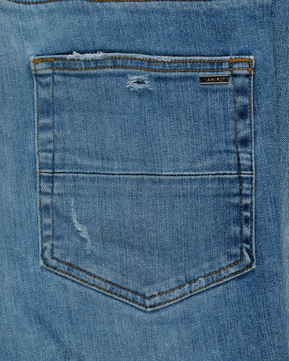 Amiri knee-ripped blue skinny jeans