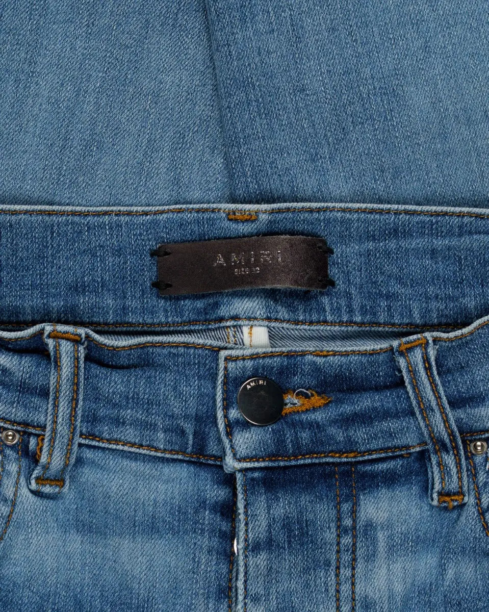 Amiri knee-ripped blue skinny jeans